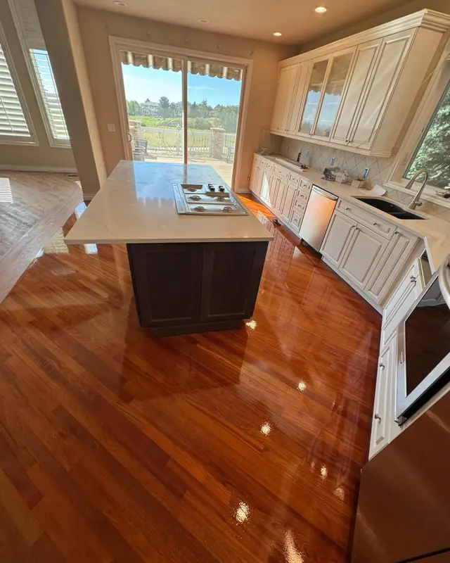 Refinished hardwood kitchen floor with glossy finish
