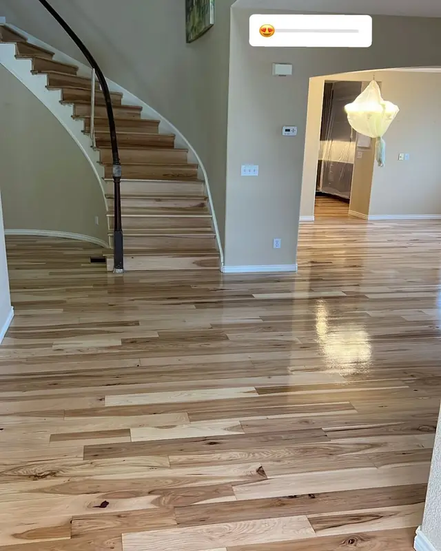 Curved staircase and refinished hardwood entry